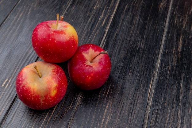 Free Photo | Side view of red apples on wooden background with copy space