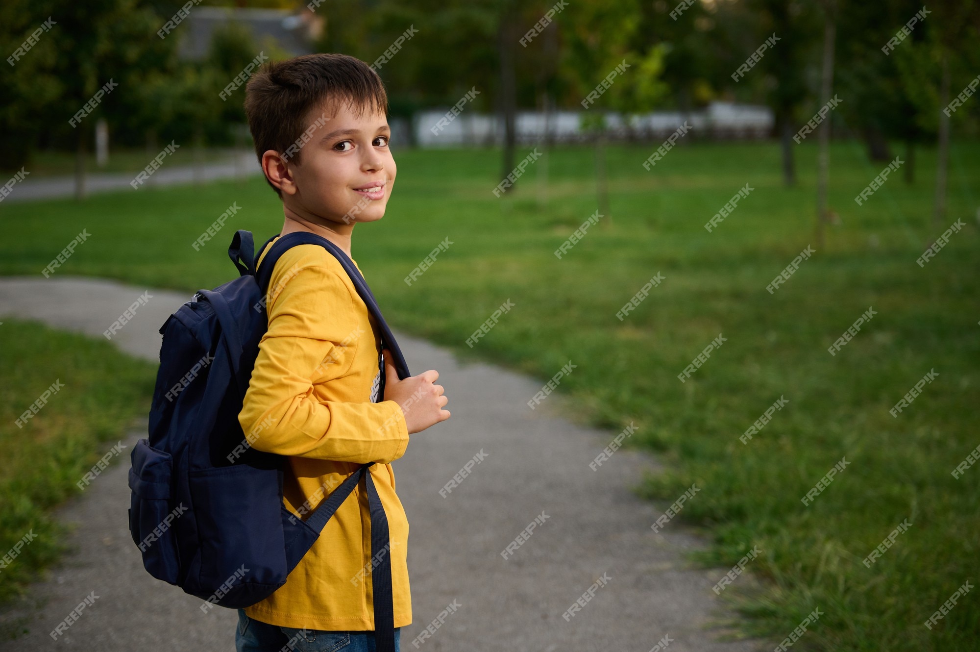 Premium Photo | Side view of a schoolboy with schoolbag backpack ...