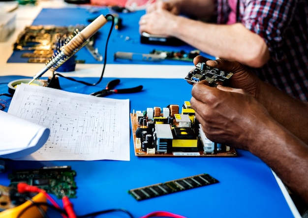 Premium Photo | Side view of technician working on computer mainboard