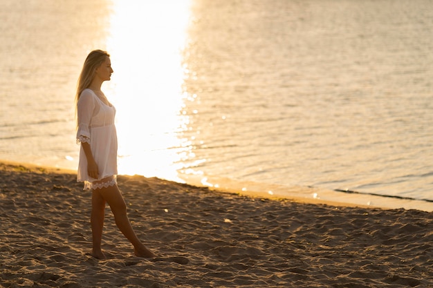 Free Photo | Side view of woman on beach at sunset