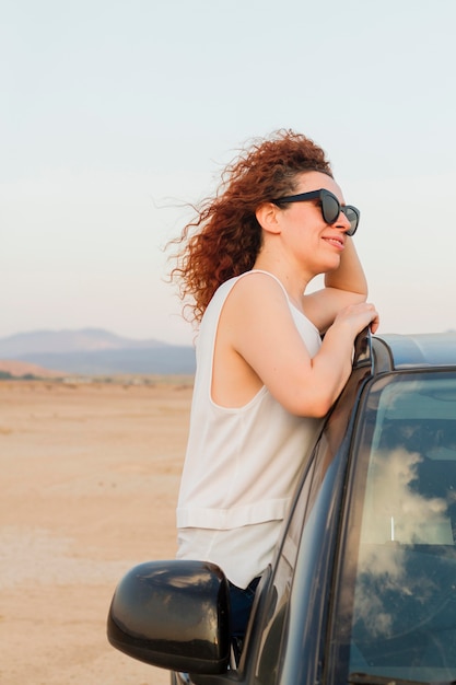 Free Photo | Side view woman on car window