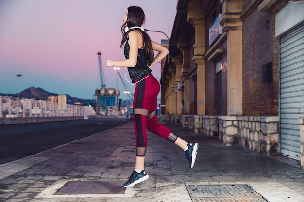 Side view woman running on pavement Free Photo