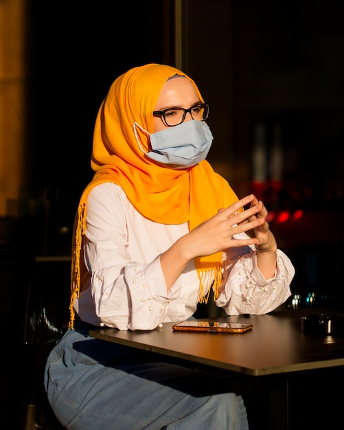 Free Photo | Side view woman sitting at table