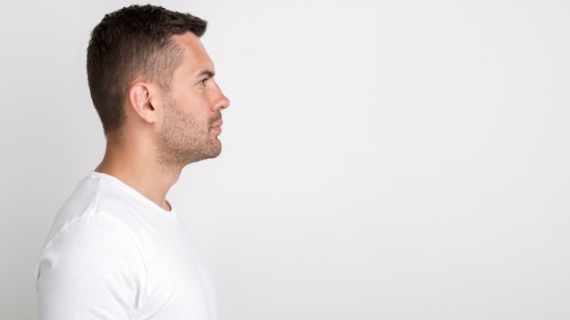 Free Photo Side View Of Young Man Standing Against White Background