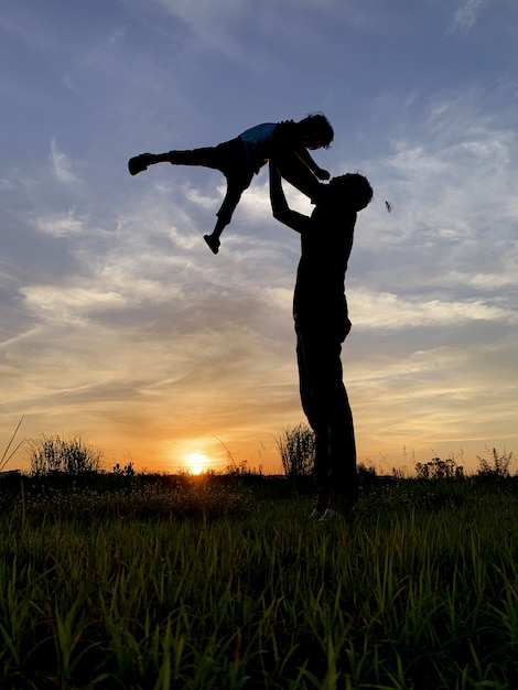 Premium Photo Silhouette Father Carrying Son Against Sky During Sunset