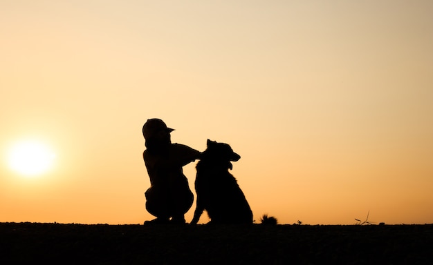 Premium Photo Silhouette Of Girl And Her Dog With Beautiful Sunset Background