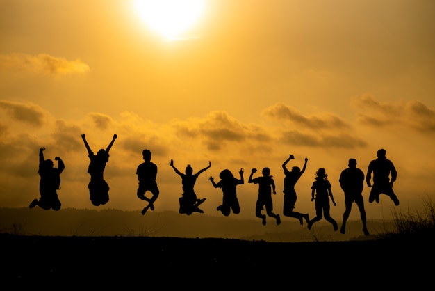 Premium Photo | The silhouette of a group of people is celebrating ...