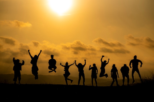 Premium Photo | The silhouette of a group of people is celebrating ...