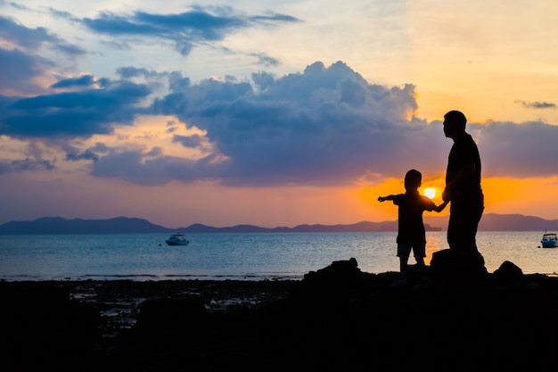 Premium Photo | Silhouette image of father and son at the beach before ...