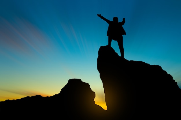 Premium Photo | Silhouette of man on mountain top over sky and sun light