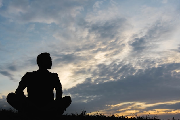 Premium Photo | Silhouette of a man sitdown with so sad in the sunset.