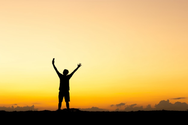 Premium Photo | Silhouette of man standing at sunset