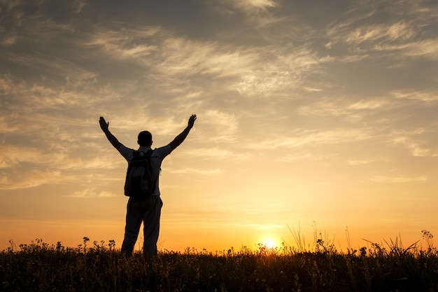 Premium Photo | Silhouette of man with arms raised up and beautiful sky