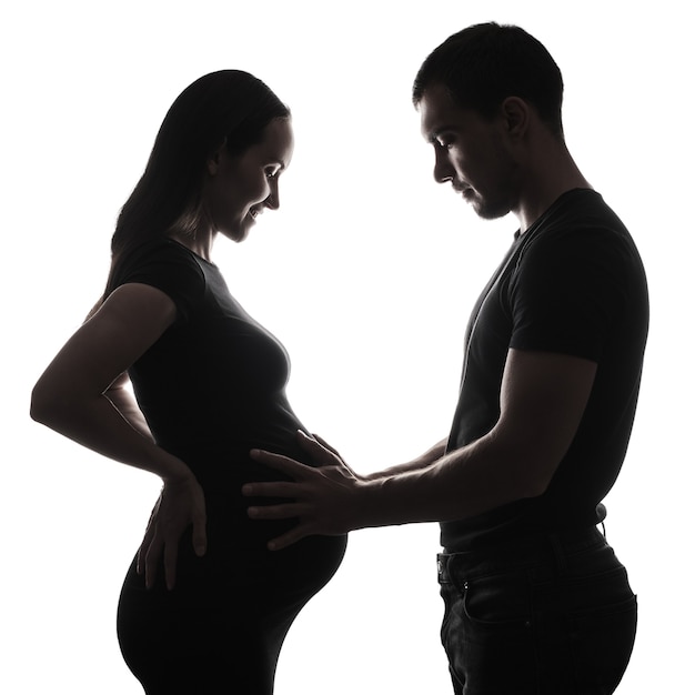 Premium Photo Silhouette Portrait Of Pregnant Woman And Man Holding Hands On Belly Of Pregnant