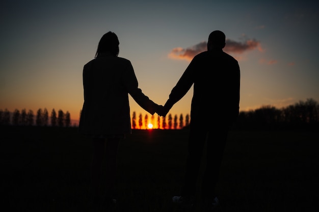 Premium Photo | Silhouette of romantic couple holding hands