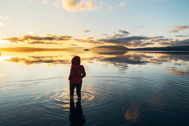 Premium Photo Silhouette Of A Woman On Her Back Inside A Quiet Lake Where The Clouds And Blue Sky Are Reflected