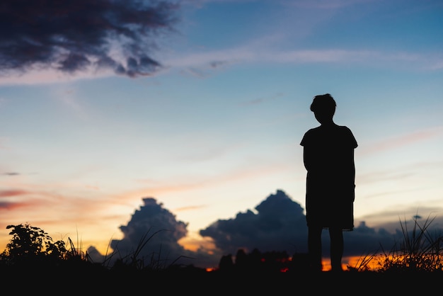 Premium Photo | Silhouette woman sad standing at sunset