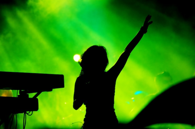 Free Photo | Silhouette of woman singing on green background