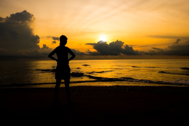 Premium Photo | Silhouette of women looking up sunrise on the beach ...