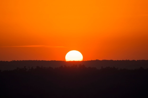 Premium Photo | Silhouette yellow half sunset orange sky and moutain