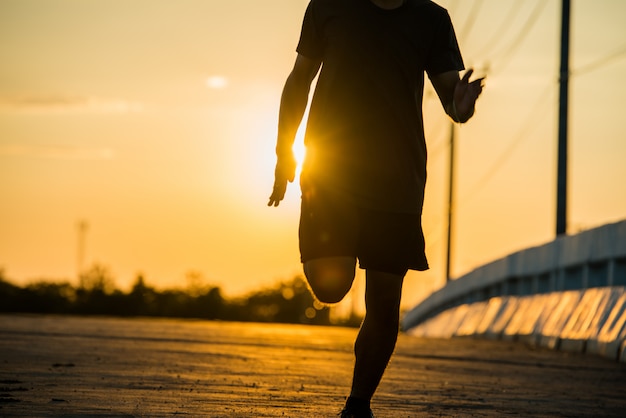 Free Photo | Silhouette of a young fitness man running on sunrise