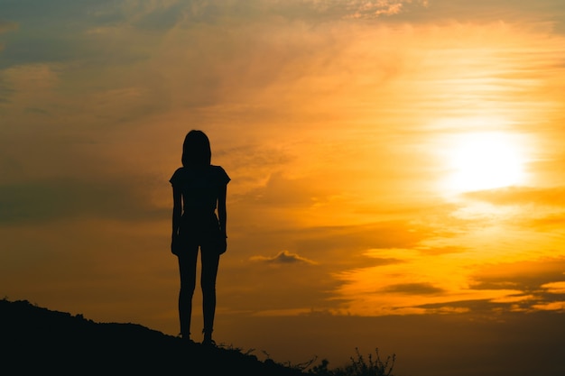 Premium Photo | Silhouette of a young woman sadly with the sky at sunset