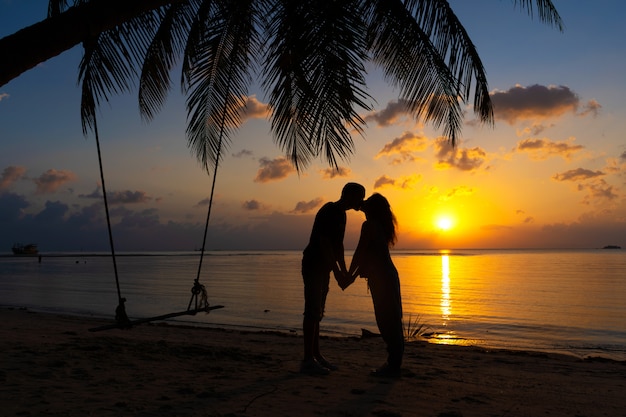 Premium Photo Silhouetted Couple In Love Kisses On The Beach During Sunset 7866