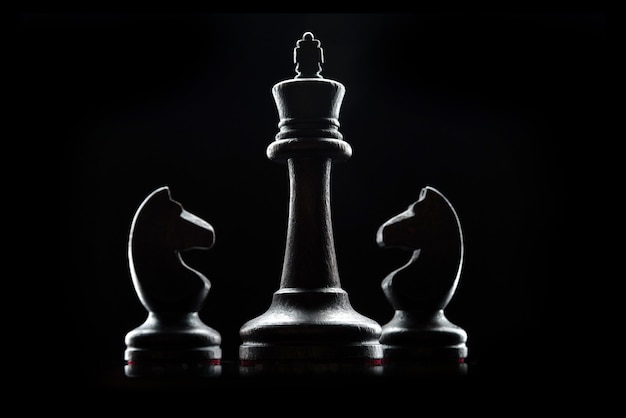 Premium Photo | Silhouettes of chess pieces isolated on a black ...