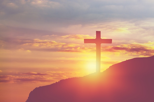 Premium Photo | Silhouettes of a cross with a bright sunbeam on top of ...