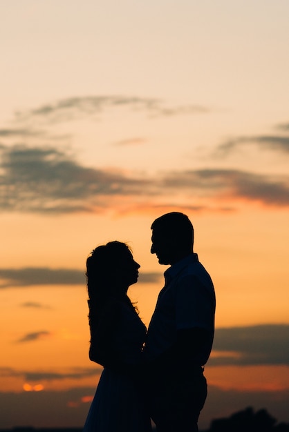 Premium Photo | Silhouettes of a happy young couple guy and girl on a ...