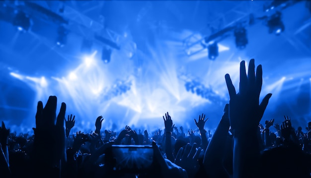 Premium Photo | Silhouettes of raised hands at a music concert. party ...