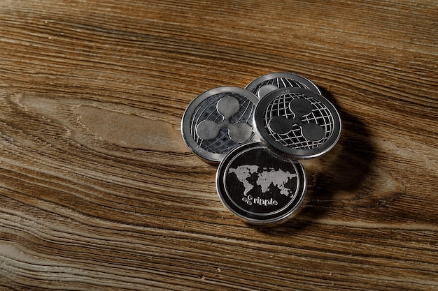 Download Premium Photo | Silver ripple coins on a black wood background