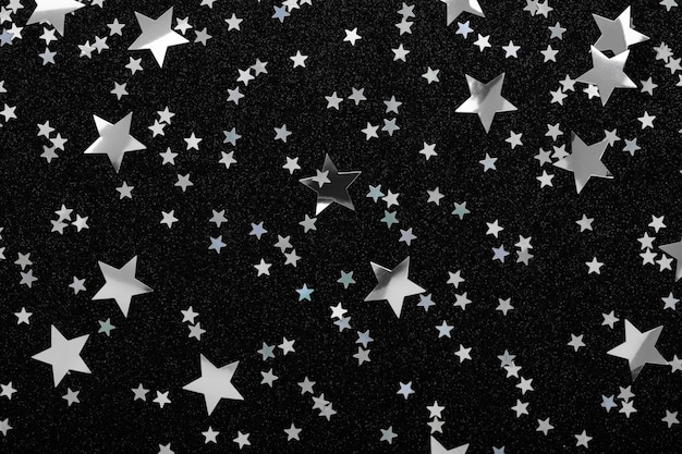 Premium Photo Silver Stars Confetti On Black Festive Holiday