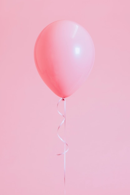 Single pastel pink balloon with a string Photo | Premium Download