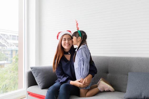 Premium Photo Sister Kisses Asian Sisters Cheek In The Living Room