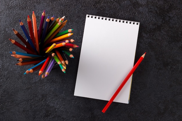 Sketch book and colorful pencils Premium Photo