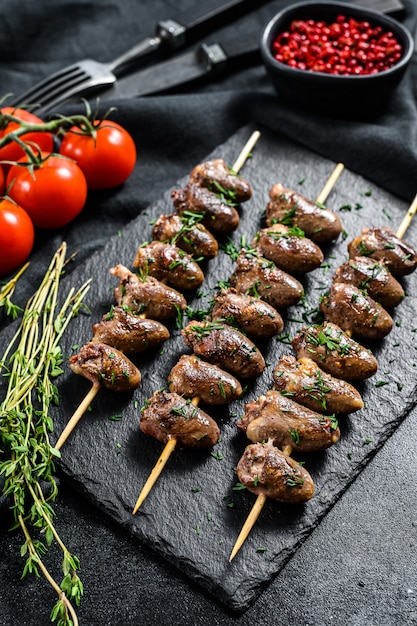 Premium Photo | Skewered and grilled chicken hearts. yakitori. black ...