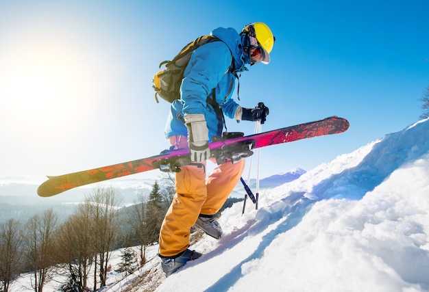 Premium Photo | Skier on slope in mountains on winter day