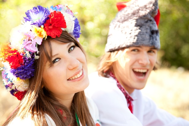 Premium Photo | Slav girl with wreath and young cossack at nature.