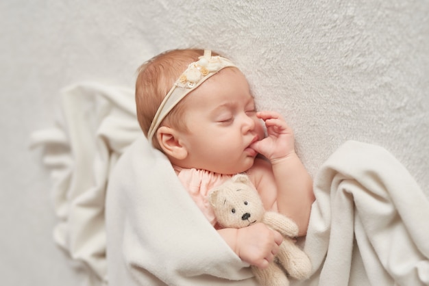 Sleeping baby 3 months on a light Premium Photo