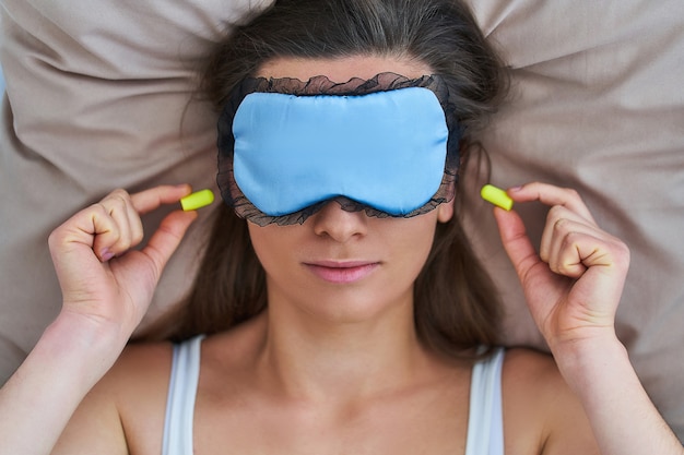 Sleeping female using eye mask and 