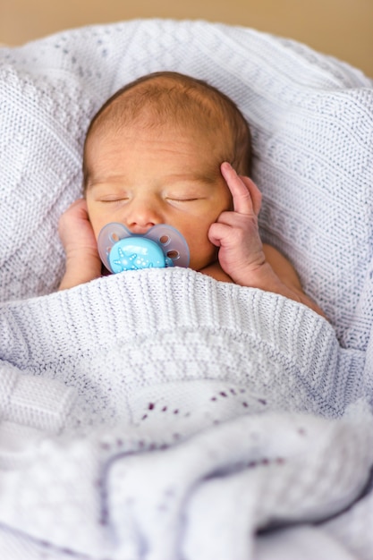 Premium Photo | Sleeping newborn baby boy with a pacifier. babyface ...