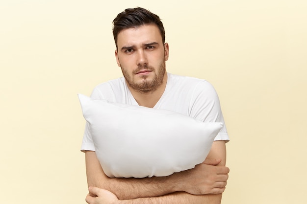 Free Photo | Sleepy young male posing with cushion. attractive guy with ...