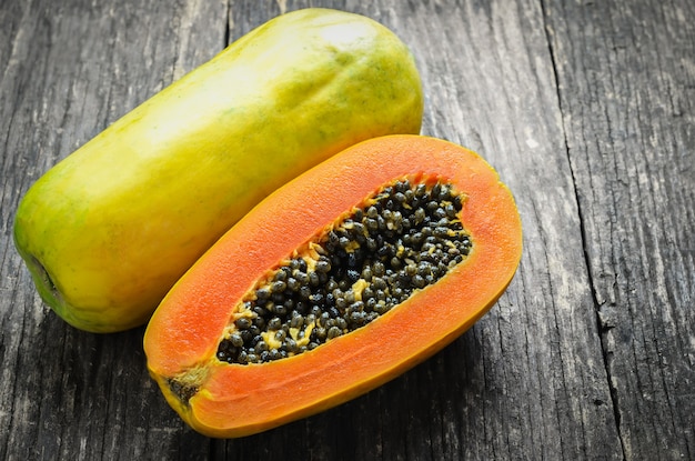 Premium Photo | Slice of ripe papayas on wooden table