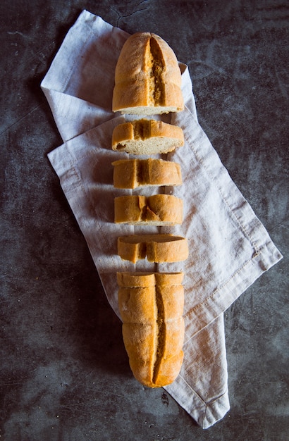 Sliced baguette on slate background top view Free Photo