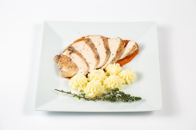 Sliced chicken breast in a sauce with mashed potatoes Free Photo