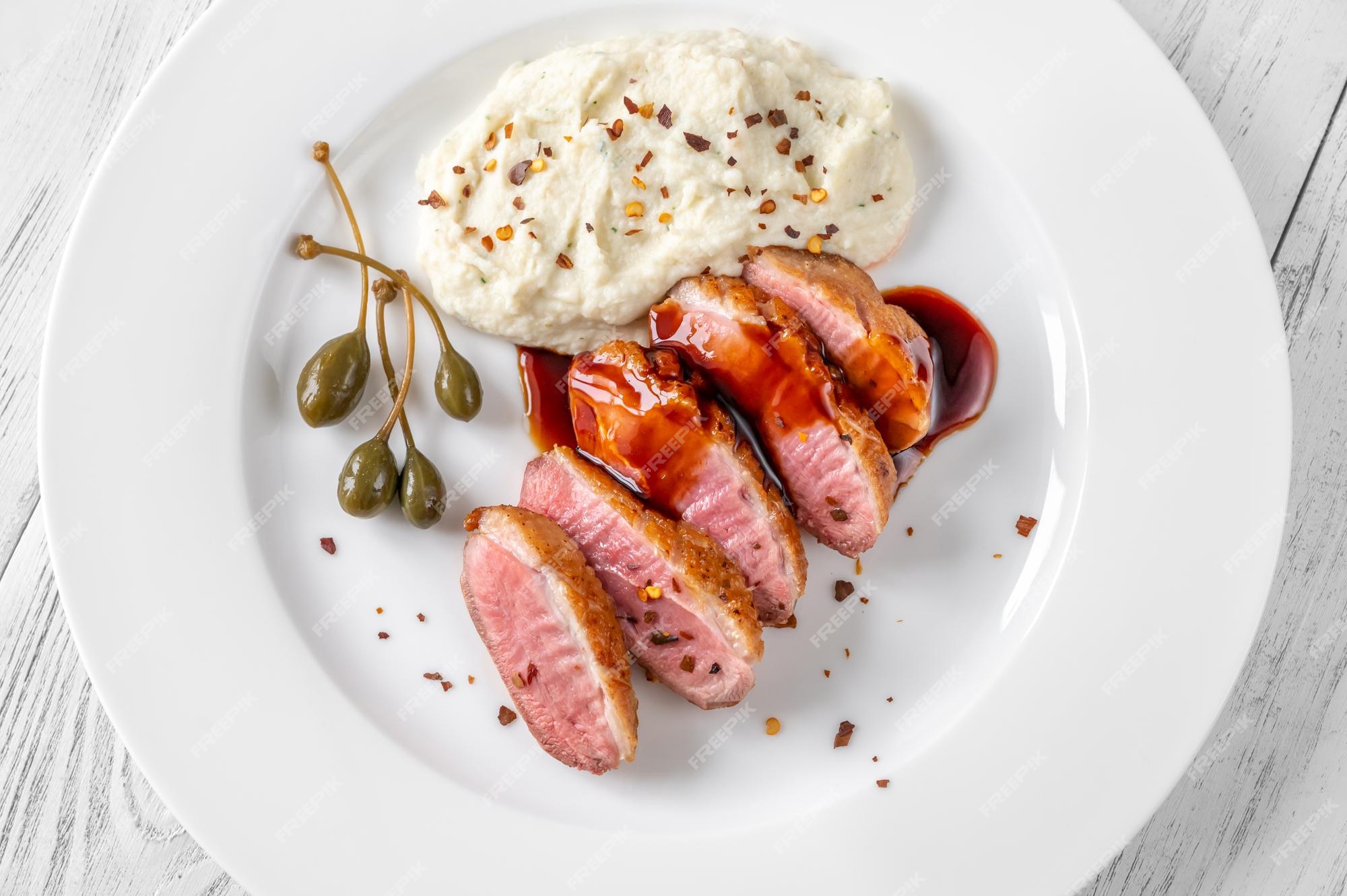Premium Photo | Sliced fried duck breast with red wine sauce