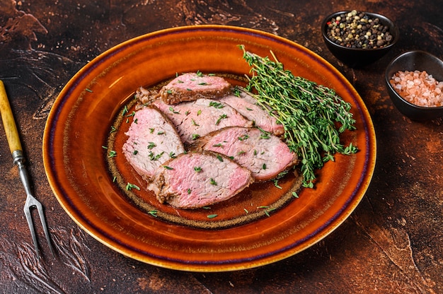 Premium Photo | Sliced roast beef sirloin tender steak on a rustic plate