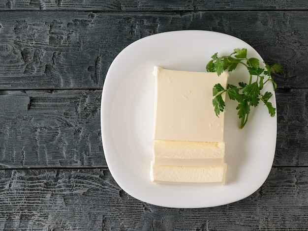 Premium Photo | Sliced serbian cheese with parsley on the village table