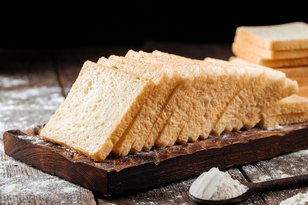 Premium Photo Sliced white sandwich bread on a wooden board